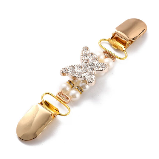 Fjärilsformat koftspänne i guldplätering med vacker rhinestone